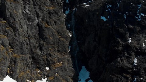 Mountain spring Waterfall during Norwegian Winter Cinematic Aerial 4K