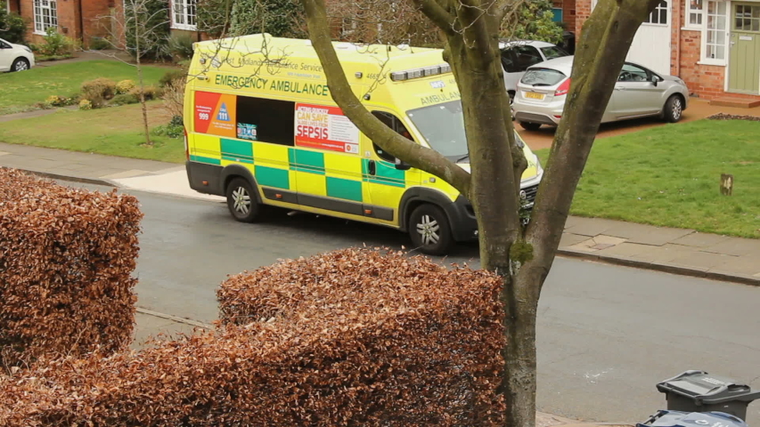 Birmingham, Selly Oak, UK, Apr 2019. British Ambulance standing in front of the house in suburban area - vertical pan. Editorial Royalty-Free Stock Footage #1039783805