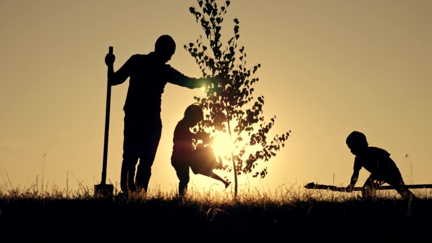 Agriculture. Farmer with his family is planting tree. Family silhouette. Agriculture concept. Happy family of farmer. Silhouette of father and two children planting and watering tree in park at sunset Royalty-Free Stock Footage #1039785623