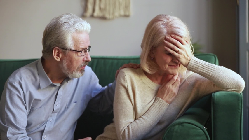 Elderly spouses sitting on couch aged wife crying feels desperate worried anxious husband comforting beloved woman showing empathy, sad life event, senile disease diagnosis, health problems concept Royalty-Free Stock Footage #1039788452