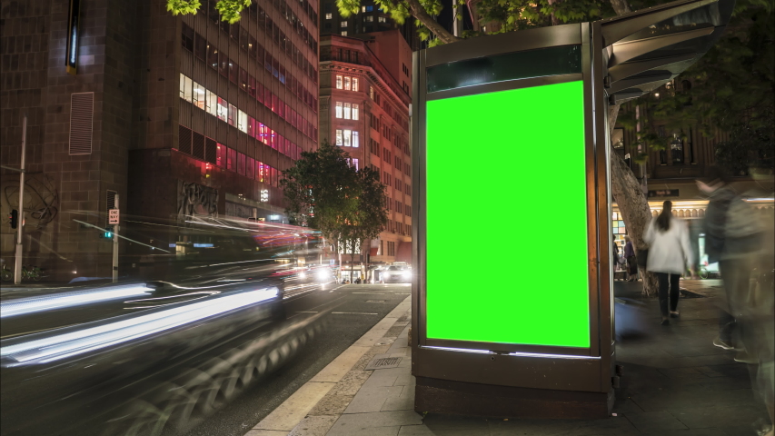 City street Billboard stand with green screen. Time lapse with commuters, people and cars. Space for text or copy. Royalty-Free Stock Footage #1039793210