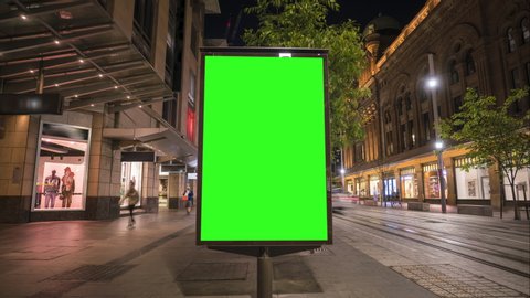 City street Billboard stand with green screen. Time lapse with commuters, people and cars. Space for text or copy.: stockvideo