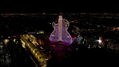 Hollywood, Florida/USA - October 25, 2019: Aerial view on New Hard Rock Casino Hotel. Guitar Hotel and Oasis Tower at Night. Light Show at Guitar Hotel Hard Rock, aerial view