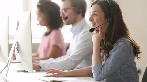 Service phone operators sit at shared desk focus on sales agent woman in headset use pc answers incoming calls talk with client provide professional support to customers sell company product concept