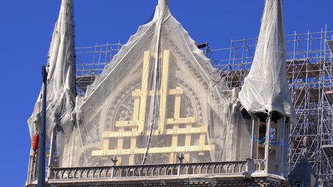 Paris, France - July 2019 : Notre Dame de Paris reconstruction, scaffoldings and work in progress on the roof and protected rose window after the fire destroyed the cathedral on April 15th 2019