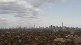 Aerial establishing shot of Toronto, Ontario with beautiful Fall colors. 4K Cinematic footage.