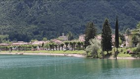Scenic small town with traditional houses and clear blue water. Summer vacation for tourists on rich resort in Italy.