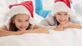 Close-up 4k video of a little girl and boy in Christmas morning against white background of a New Year tree.