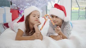 Warm Christmas atmosphere in which joyful sister and brother playing with candy canes, imitating a swordfight. Sister's candy gets broken and she started to cry. - Powered by Shutterstock - Get 15% off with code: PIKWIZARD15