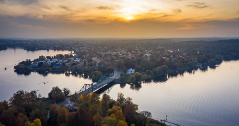 View to Glienicke Bridge, the Bridge of Spies. The Bridge spans the Havel River to connect Berlin and Potsdam. The Bridge is symbol of German Reunification. Boats are moving at the River Havel.