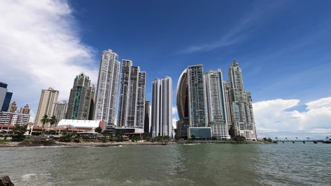 Scenic view of waterfront in Panama City in Panama and skyline of Punta Pacifica district. Sunny day. Modern architecture with skyscrapers. Looking at view of ocean and modern buildings.