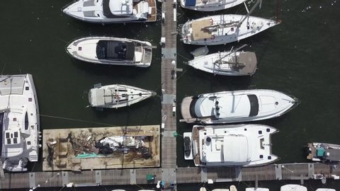 Drone flying over white Sailing Boats and Motor Yachts tied to the Pier of a Yacht Club in Cartagena Bay, Colombia on the Caribbean coast of South America in 4K.: film stockowy