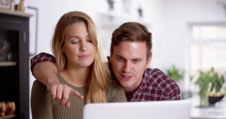 4K Man annoying his partner by trying to be affectionate while she works on laptop. Slow motion.