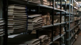 Bookshelves in an old library or archive room. Old room with books and documents with a basement light. Footage for the concept of training and historical news. - Powered by Shutterstock - Get 15% off with code: PIKWIZARD15