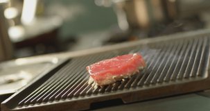 High quality video of steak on the grill . Roast grilling tenderloin fresh juicy beef filet with lines . Closeup shot of cooking grilled meat in barbecue griller. Shot on Red Cinema Camera .