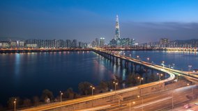 Time Lapse light landscape and cars runing on the road with a river and beautiful bridge at Night time and high building for background in Seoul,South Korea.