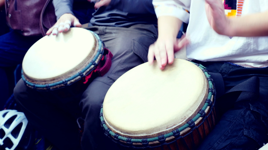 Close Up Of Hands Playing African Drum Djembe. Summer evening. Slow motion