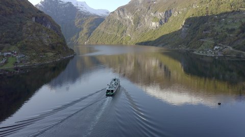 Ferry Passing Through a Fjord in Norway During the Fall