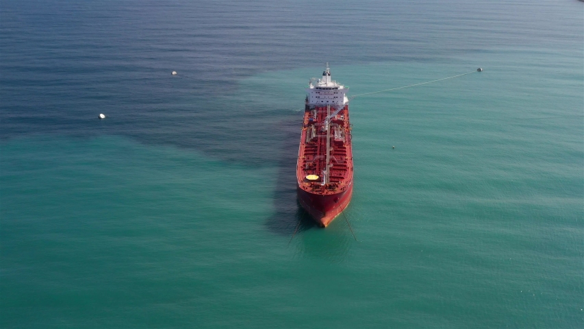 Oil spills out of a ship to Mediterranean Sea- Aerial View
Drone view of oil Chemical Tanker Tied with strings Spills oil in the sea
 | Shutterstock HD Video #1039851440