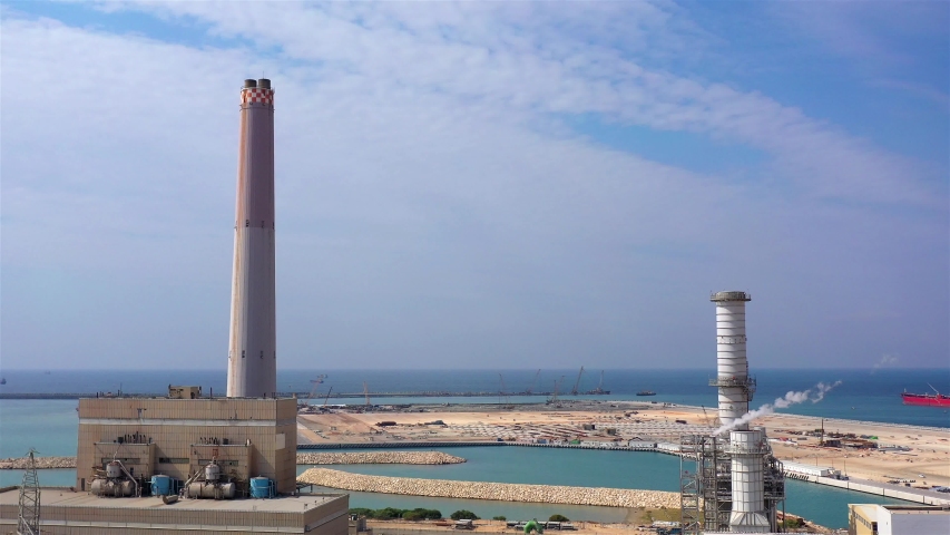Power Plant with chimneys, Harbor and Mediterranean sea, Aerial  
Drone view over Power Plant with chimneys And harbor in the the background
