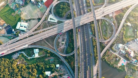Aerial view of highway interchange - Transport concept footage, busy roads of morning golden hour, birds eye top view use the drone in Pingzhen Interchange System, Taoyuan, Taiwan.
