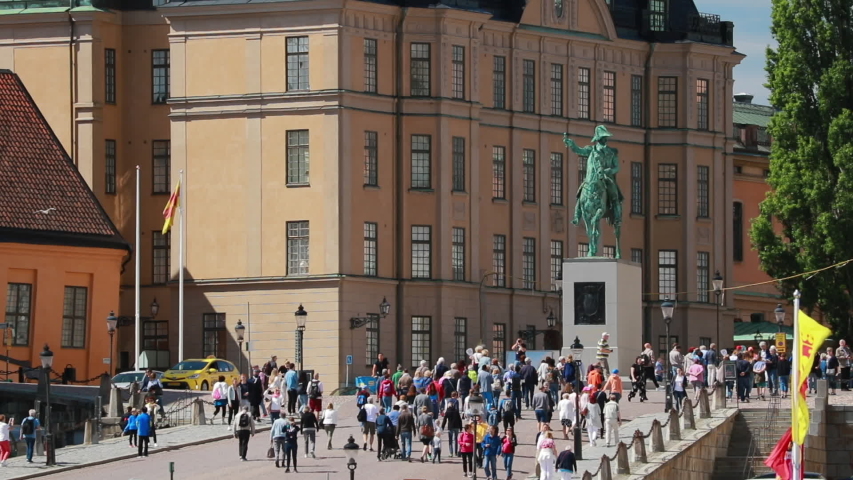 Stockholm, Sweden. Crowd Of Tourists People Walking In Stockholm Old Town. Gamla Stan In Summer Day. Famous Popular Destination Scenic Place. UNESCO World Heritage Site. Karl XIV Johans Satatue