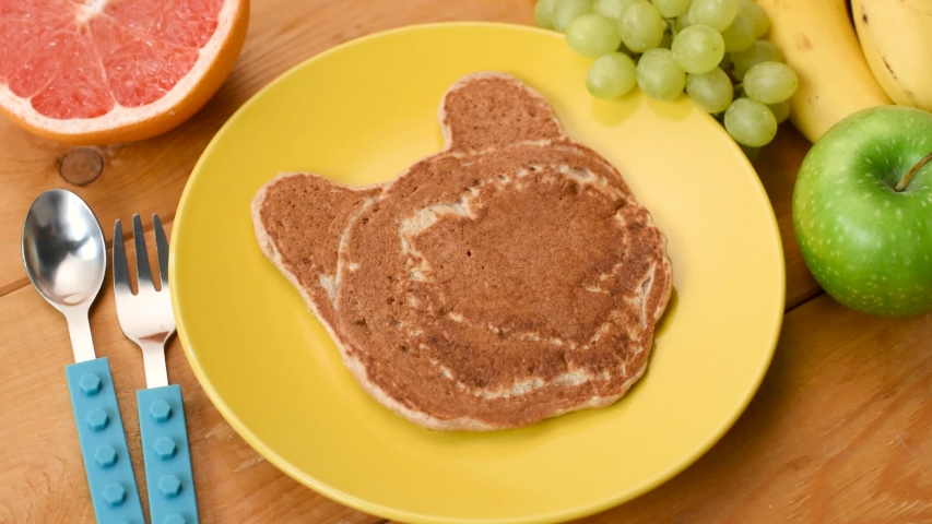 Making breakfast for kids in time lapse. Food art. Funny bear shape pancake with chocolate spread and fruits. Kids meal Royalty-Free Stock Footage #1039863023