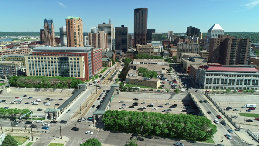 Drone aerial of downtown St. Paul, Minnesota, with buildings, highway and vehicle traffic. Themes of infrastructure, transportation, congestion, city planning. Prores file, shot in 4K.