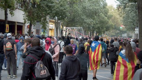 BARCELONA, SPAIN – OCTOBER 18, 2019: Tension and danger rise as a mob protesting for Catalonia independence tears down fences and cheers near Via Laietana in Barcelona, Spain on a day of destruction.