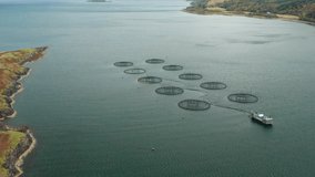Fish farms in Scotland. Beautiful aerial footage with blue waters. Salmon farms. Fish farming.