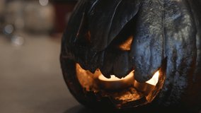 Halloween pumpkin head jack lantern with candles on a black background. Halloween holidays art design, holiday