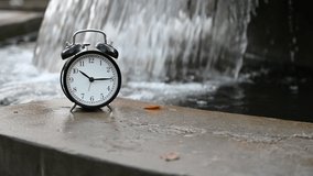 Video concept of a waterfall flowing time in a park on an autumn day.