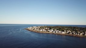 Aerial drone video of the ocean coastline and homes at Short Sands Beach near Cape Neddick and York, Maine, United States of America