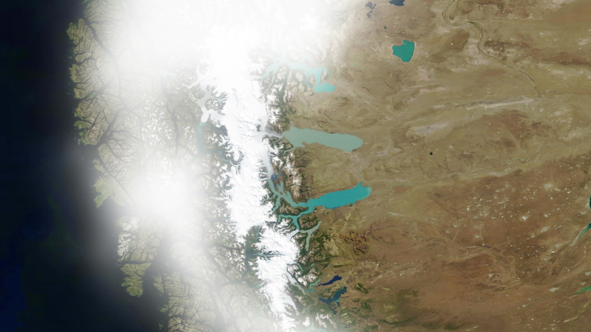 Aerial satellite view of mountains glaciers, lakes and ocean coastline with flying clouds, Argentina Los Glaciares national park. Contains public domain image by Nasa