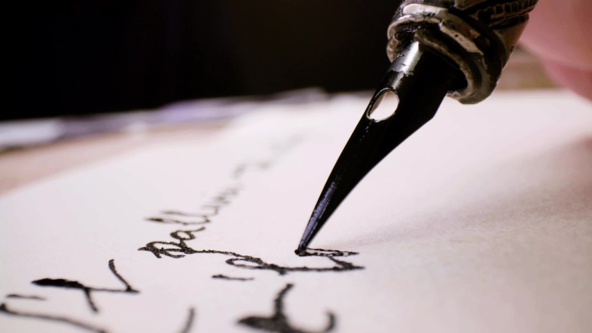 Calligraphy in slow motion. Pan shot of hand written page. Vintage ink pen and quill pen Royalty-Free Stock Footage #1039900691