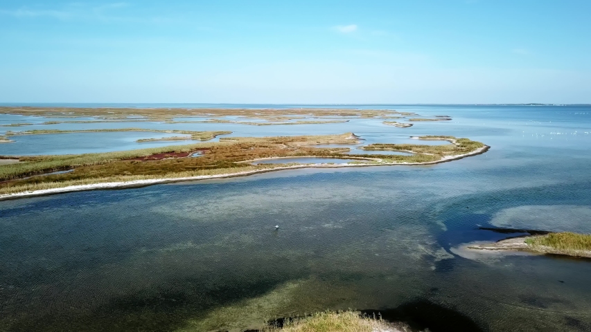 aerial view of flocks of birds over sea, Aerial view of pelicans flying over shallow sea, aerial view of shallow sea and many islands,