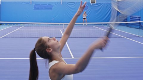 Tilt up shot of young tennis athlete serving ball and winning with ace Stock Video