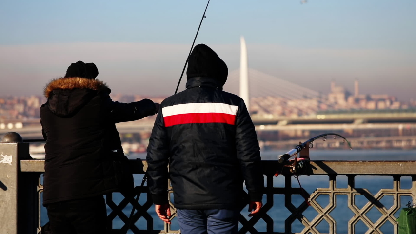 Fisherman fishing with a spinning rod.