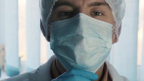 Portrait of a handsome smiling doctor removing face mask, close up - Powered by Shutterstock - Get 15% off with code: PIKWIZARD15