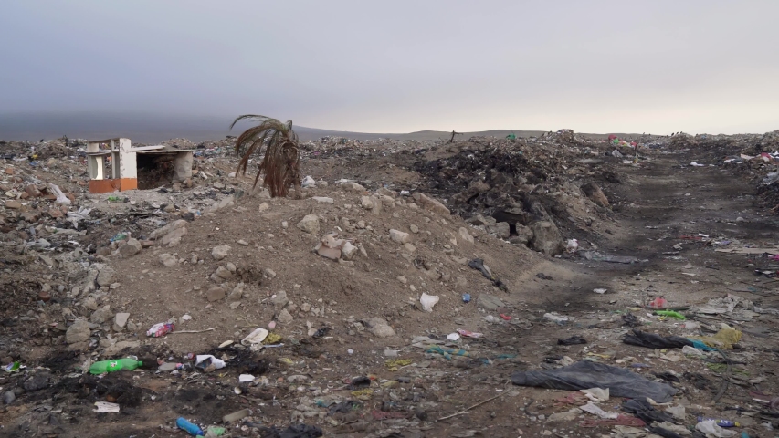 Garbage dump in a landscape with a hut of waste in the third world. CHICLAYO, PERU, DECEMBER 2017 | Shutterstock HD Video #1039936043