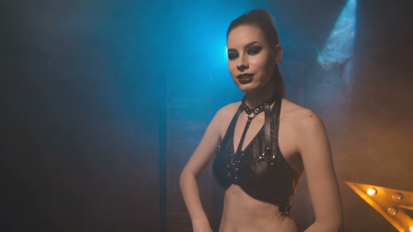 Beautiful woman in black lingerie and leather belt 