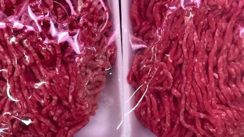 Ground beef meat in a meat market ,  minced meat in packages in a "Macro" hypermarket.