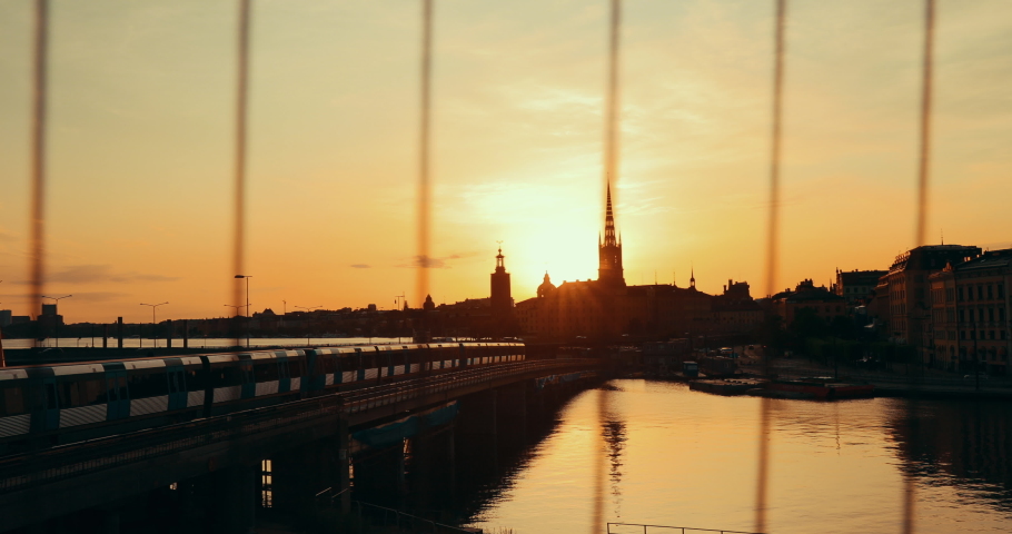 Stockholm, Sweden. Sunset Sun Shine Through Dark Silhouette Of Riddarholm Church In Stockholm Skyline. Scenic View Of Gamla Stan Old Town In Dramatic Sunshine Sunlight. Popular Destination Scenic. 4K