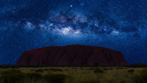 Australia - Aug 23, 2019: Spectacular Uluru by night with milky way, stars field and galaxies. Uluru-Kata Tjuta National Park in Northern Territory, Central Australia. Cinemagraph loop background