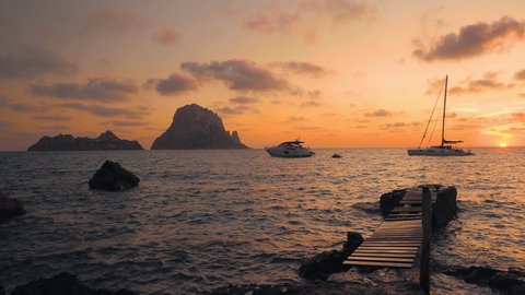Sunset on the beach of Cala D´hort, next to an old jetty and overlooking the islets of Es Vedrá, on the idyllic island of Ibiza, Balerares, Spain