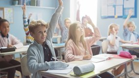 Elementary Classroom of Diverse Bright Children Listening to the Teacher Giving a Lesson. Everyone Raises Hand Knowing the Right Answer. Brilliant Kids in School Learning Science, Creative Thinking - Powered by Shutterstock - Get 15% off with code: PIKWIZARD15