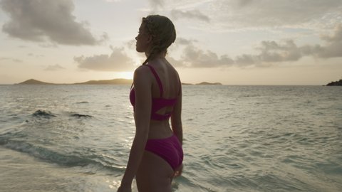 Beautiful woman walking on beach at sunset / Jamesby Island, Tobago Cays, St. Vincent and the Grenadines