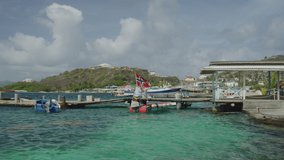 Wind blowing boats moored at waterfront marina / Clifton, Union Island, St. Vincent and the Grenadines