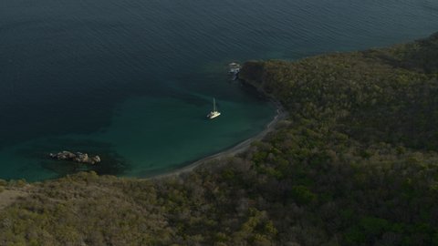 Aerial view of catamaran boat in bay near shore / Anse La Roche bay, Carriacou, Grenada