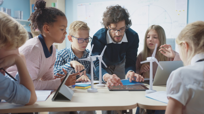 elementary school classroom enthusiastic teacher holding Stock Footage ...